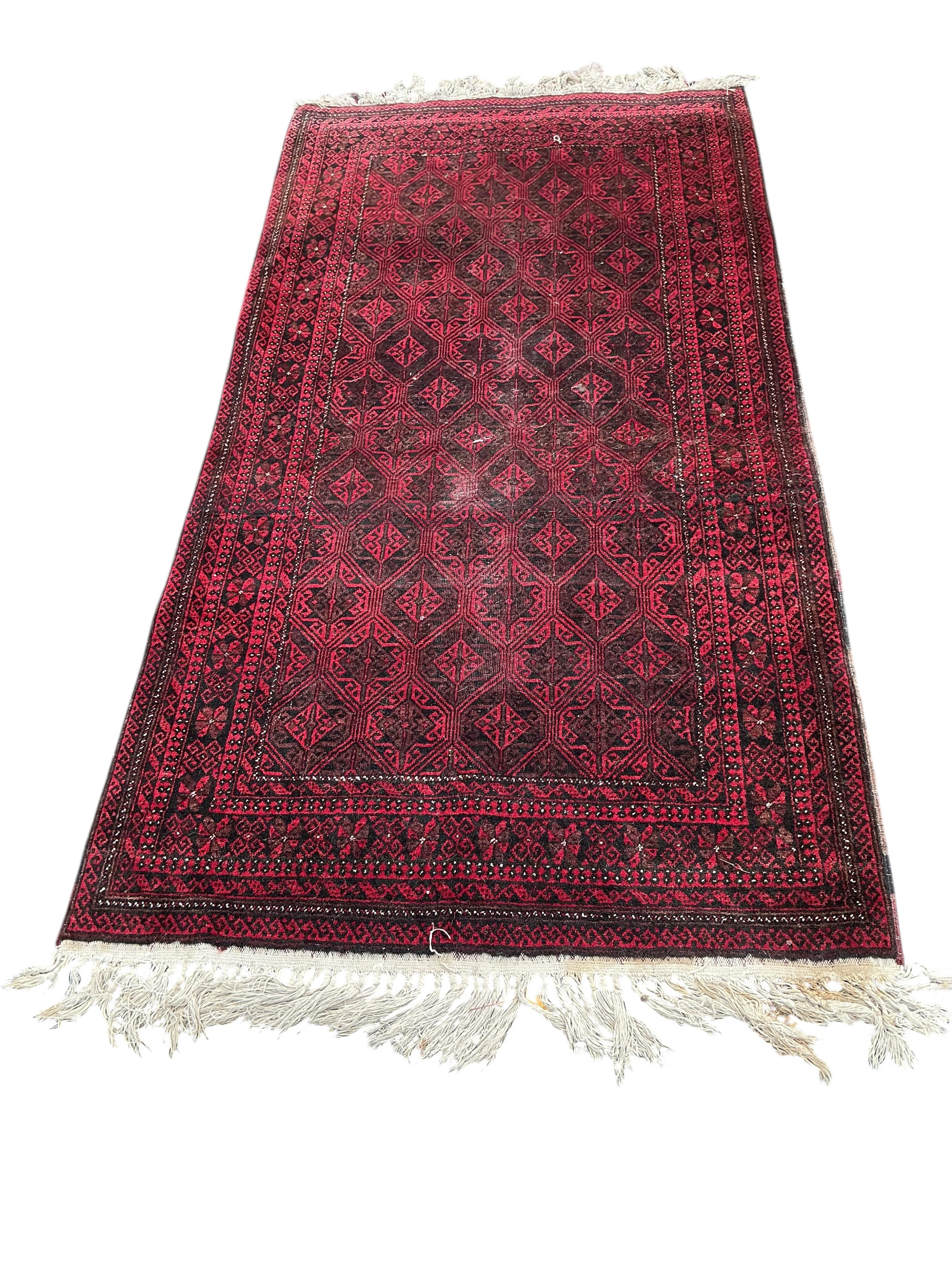 A Belouch red ground rug and an Afghan rug, 180 x 100cm and 155 x 105cm